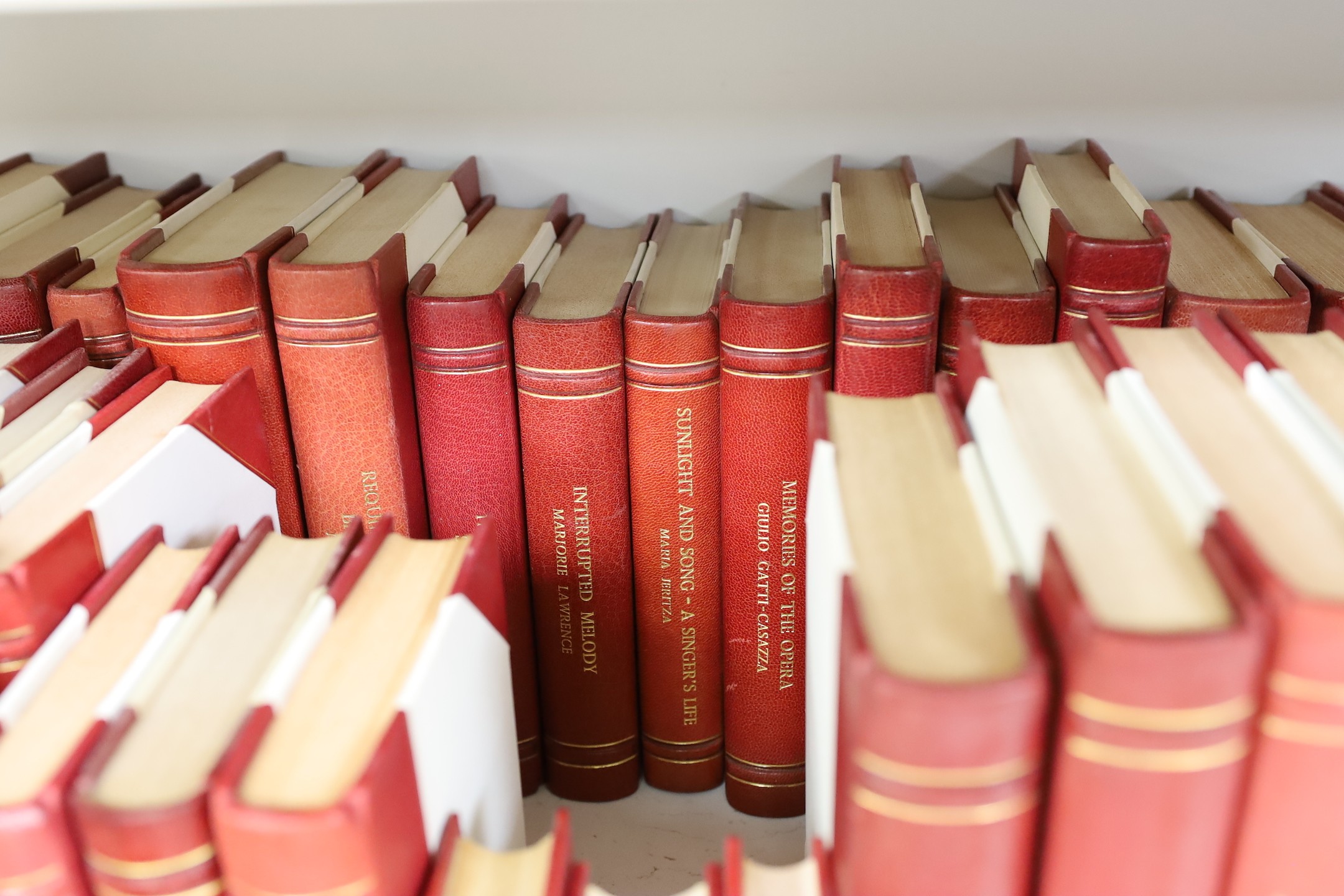 A collection of 19th and 20th century works on opera related biographies, autobiographies and histories, bound in red morocco by EA Weeks, London, approx 66 altogether